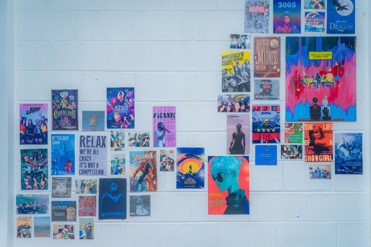 Colorful Sinhalese and Chinese children’s books neatly arranged on a white bookshelf for young readers.