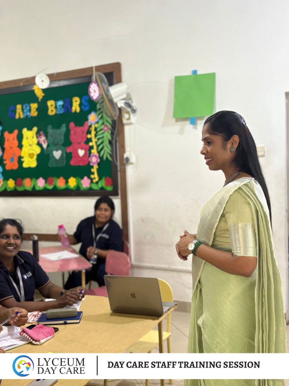 Lyceum Day Care staff training session with teacher leading workshop, team engaged in child care development.