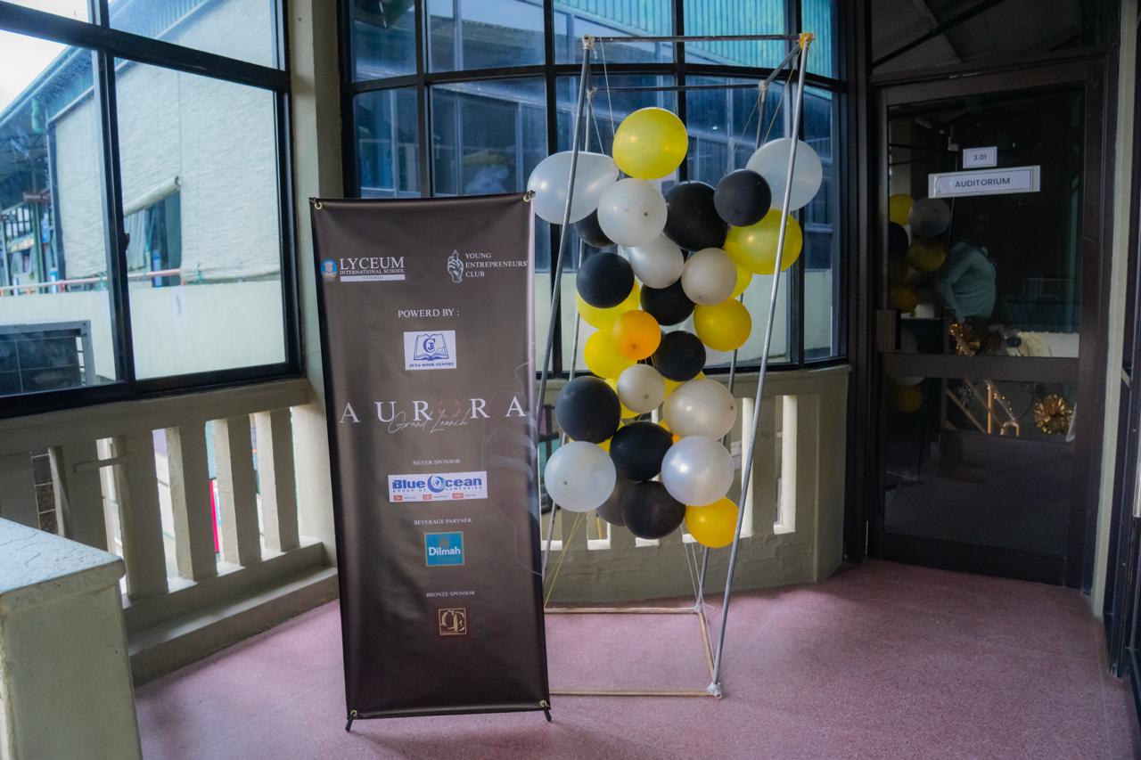 Aurora Grand Launch event entrance at Lyceum International School with banner and festive balloon decorations.