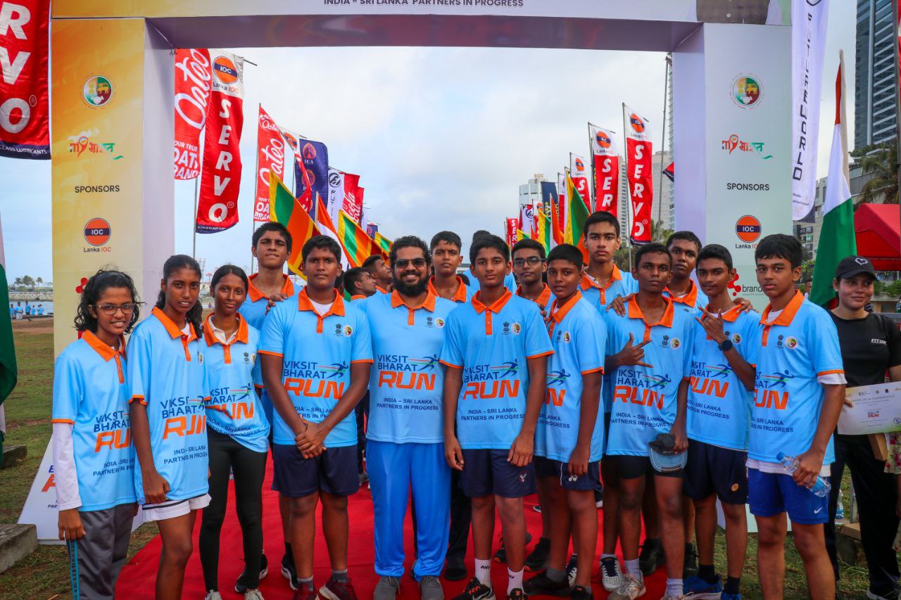 Young runners at Viksit Bharat Run India-Sri Lanka event, group unity, colorful banners, and teamwork.