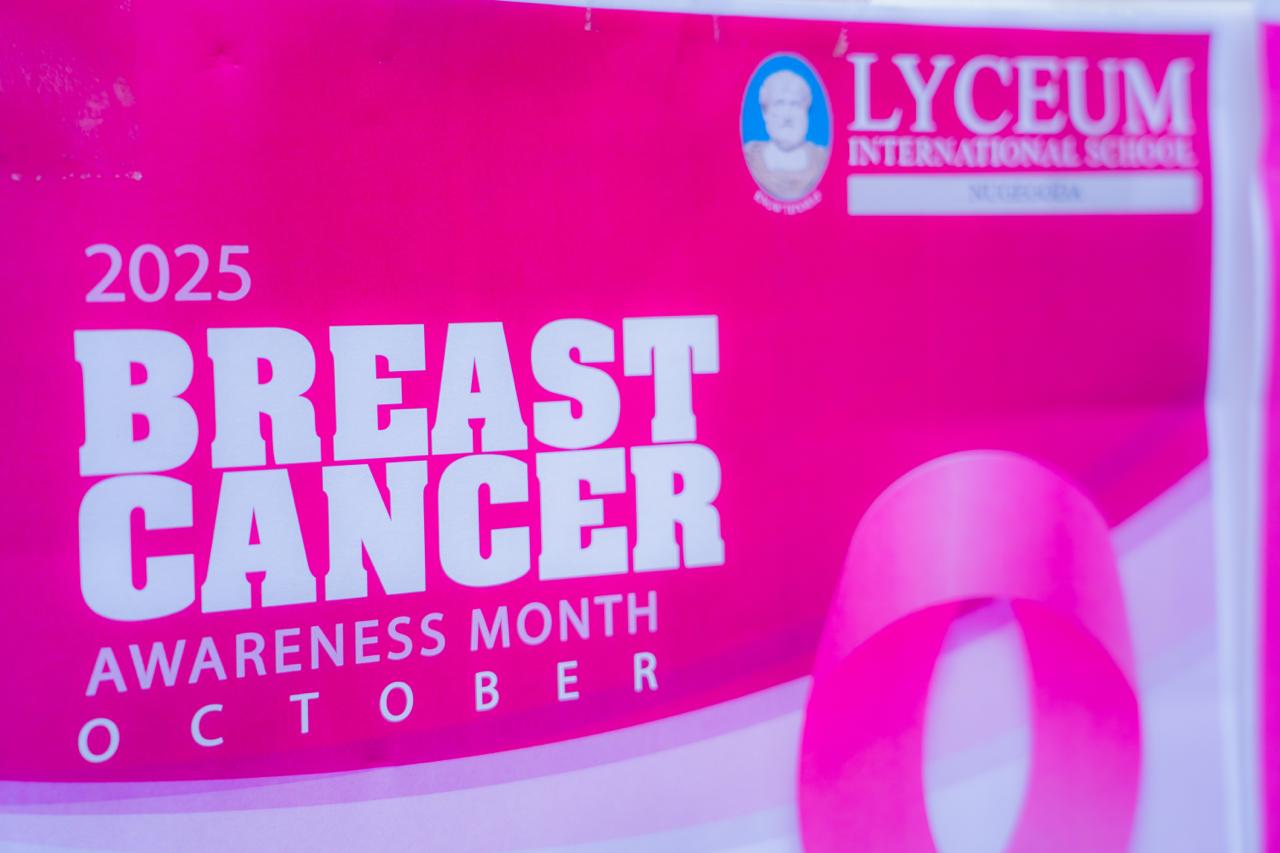 Modern office workspace with laptop, coffee cup, and documents on a clean wooden desk.