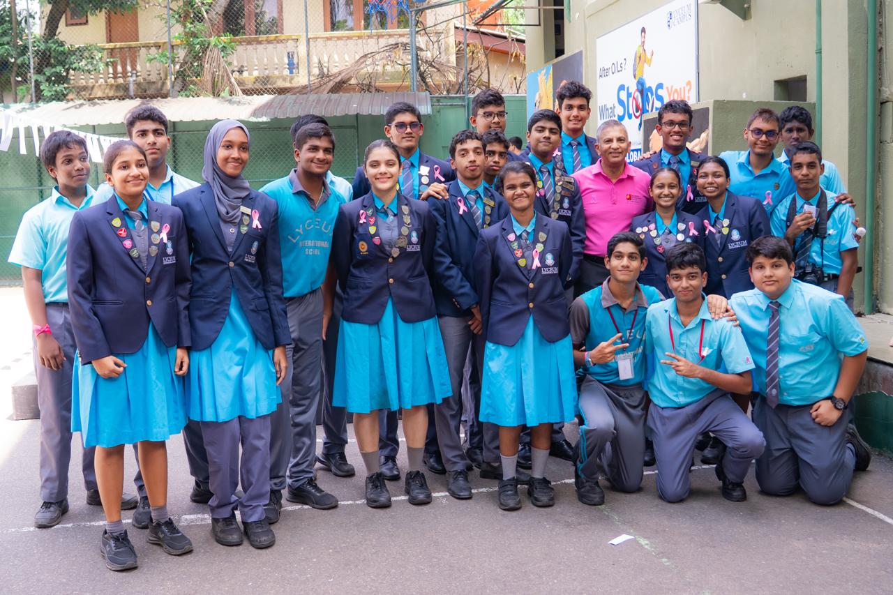 Lyceum International School students and teacher celebrate leadership and Pink Ribbon Day outdoors, showing unity.