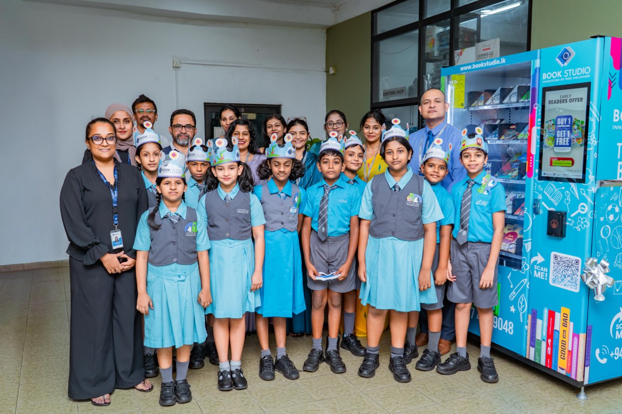School children and teachers unveil Book Studio book vending machine, promoting reading and literacy.