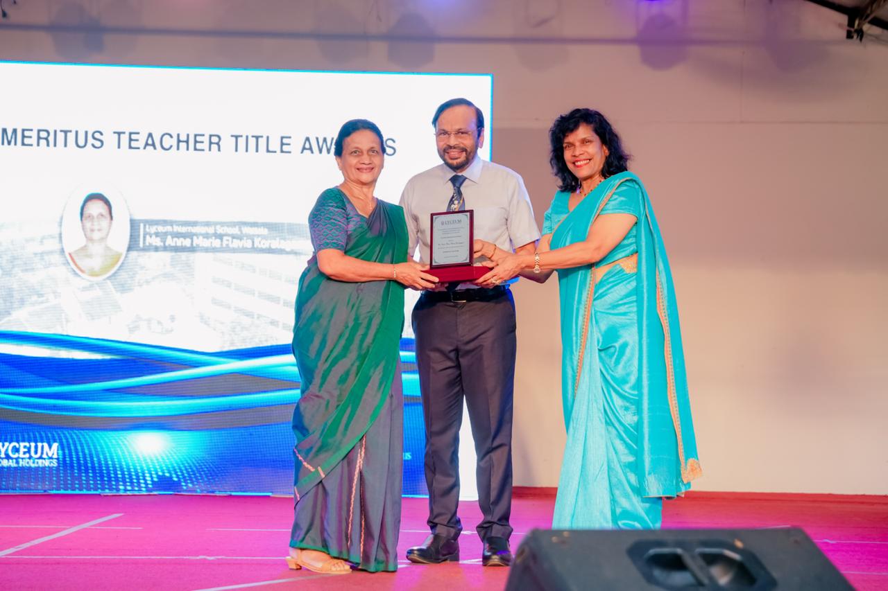 Lyceum International School teachers receive Emeritus Title Award on stage during award ceremony.