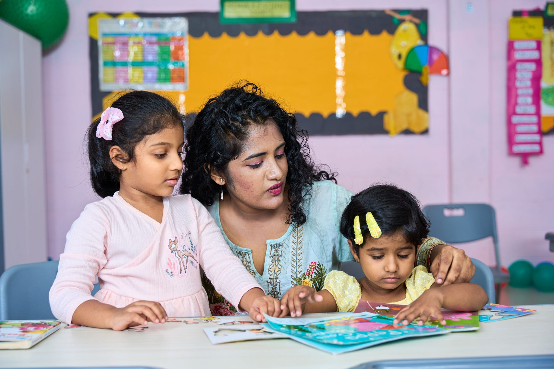 Teacher Guiding Young Children in Classroom Reading Activity Teacher reading with young children in classroom at Lyceum Leaf School Kadawatha, early childhood education.
