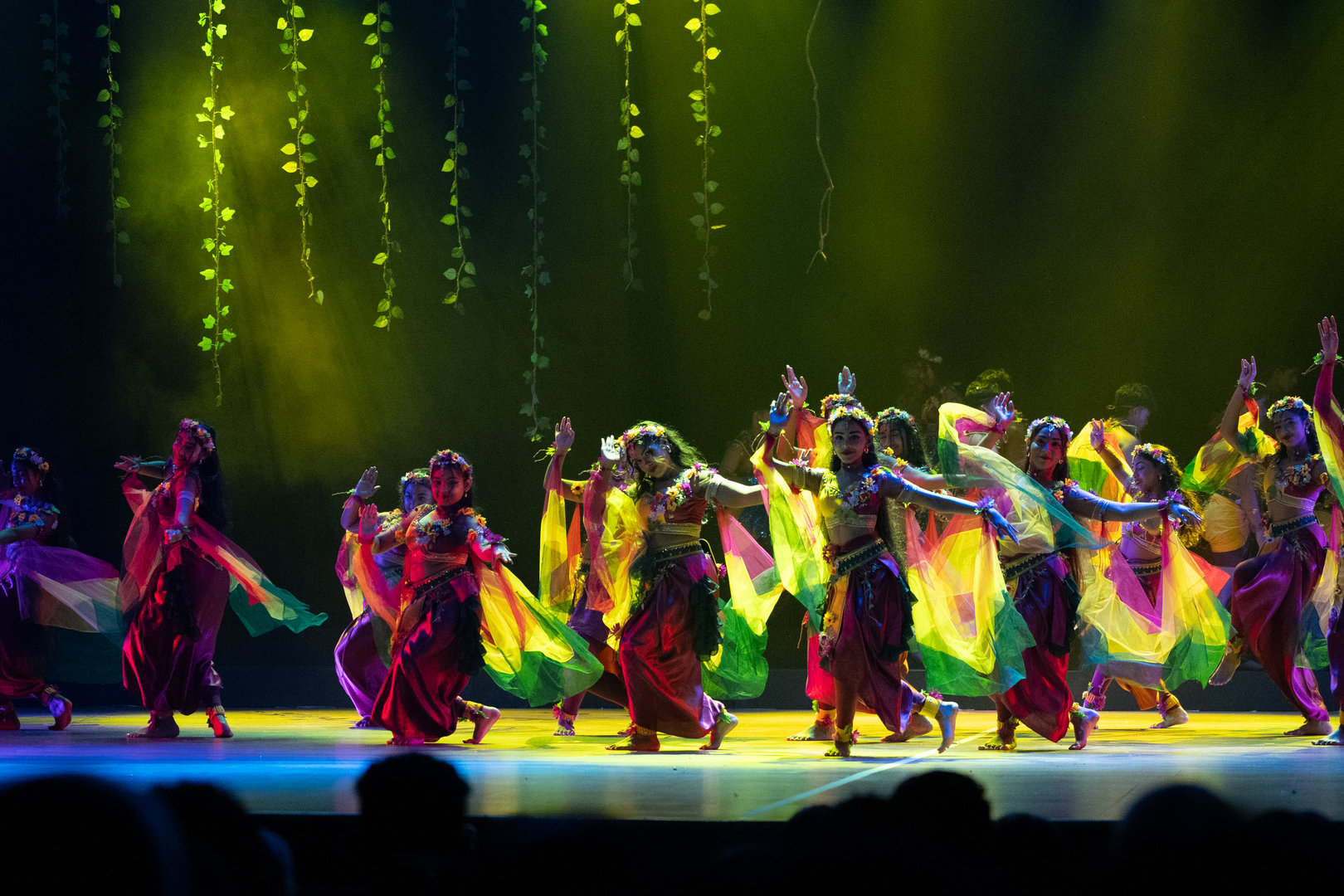 Colorful Children’s Dance Performance With Traditional Costumes Children in vibrant traditional costumes perform a synchronized cultural dance on a festively lit stage.