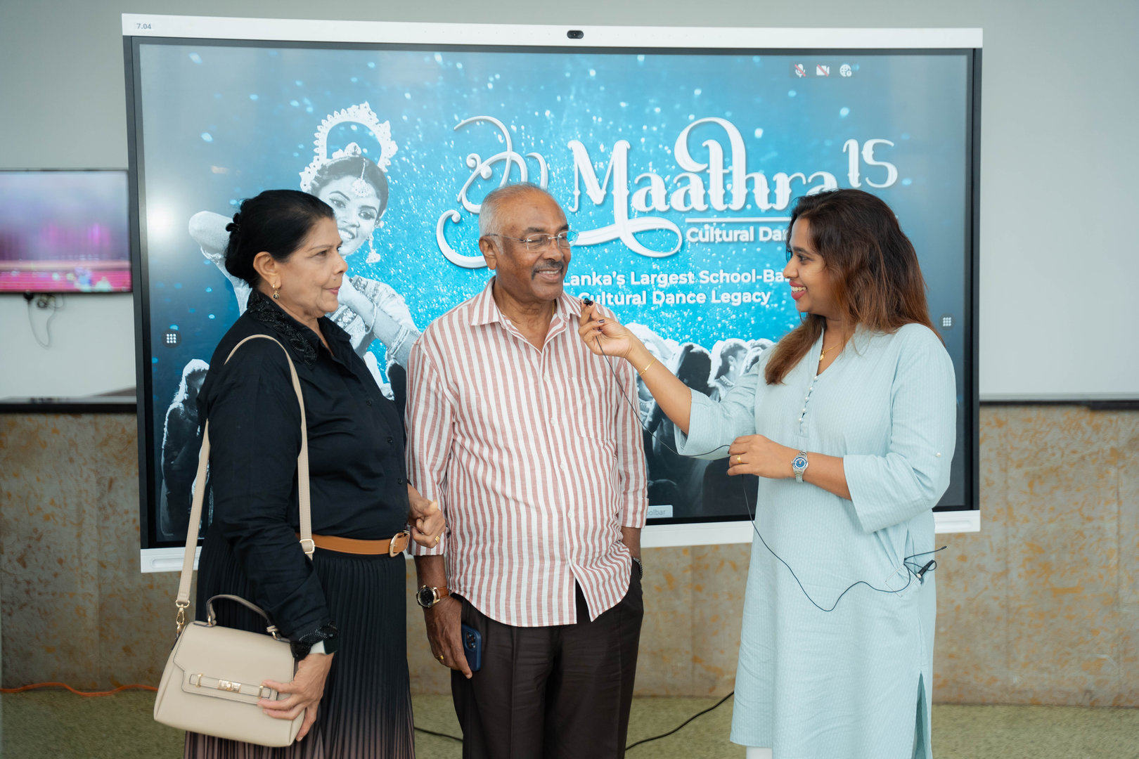 Interview at Maathra 15 Sri Lankan Dance Celebration Elderly man interviewed on stage at Maathra 15 Sri Lankan dance celebration with smiling guests.